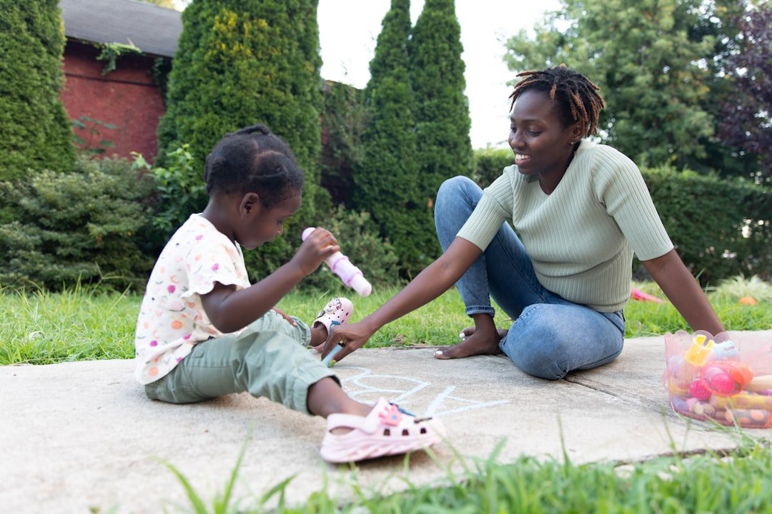 a-person-and-a-child-playing-with-toys-on-a-sidewalk-4cc1ikcpxbe