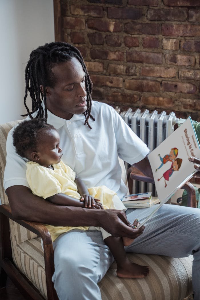 A father reads a storybook to his young child, fostering a sense of bonding and learning.